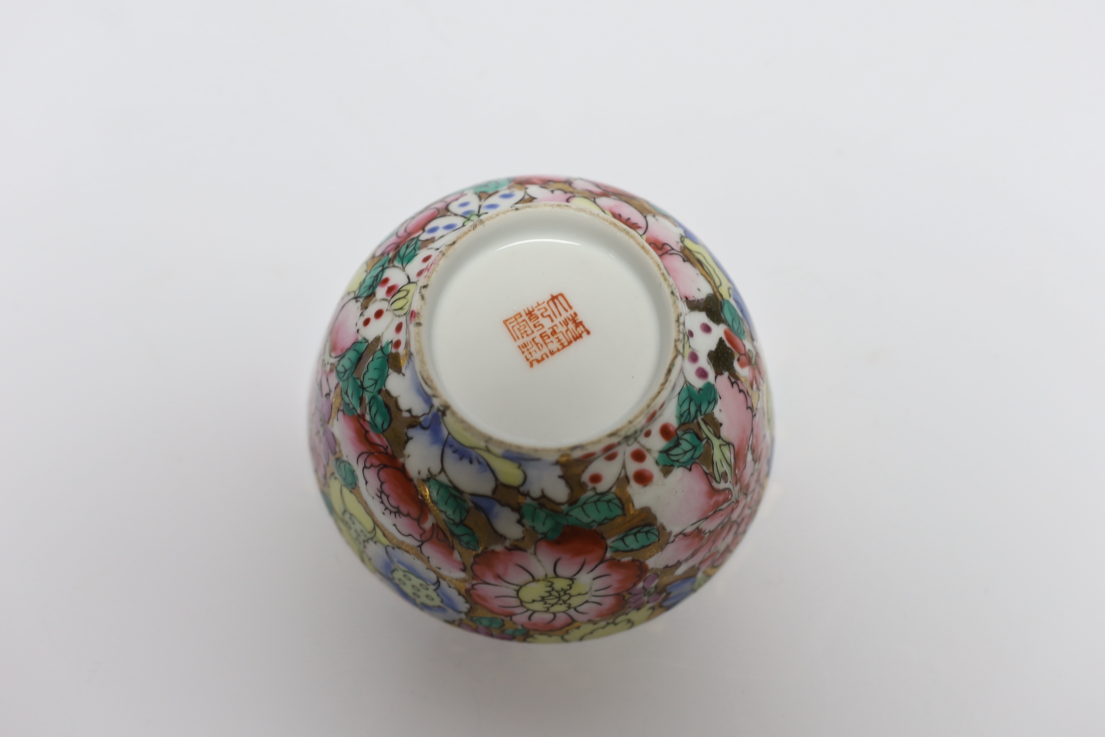 A small circular Chinese porcelain bowl having polychrome 'millefiore' and gilt decoration, diameter 11.5cm, red seal mark to base